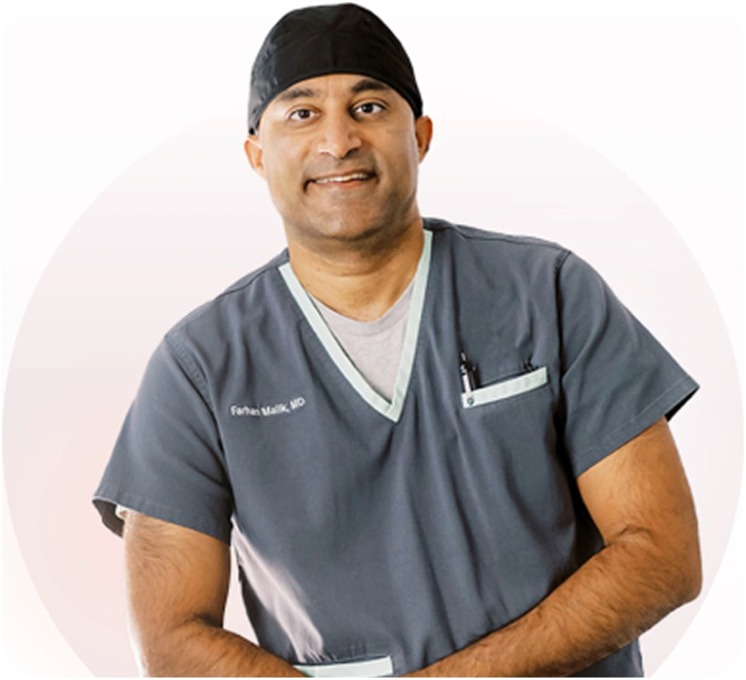 Dr. Farhan Malik, MD, in surgical scrubs and headband, smiling at camera